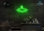 Astronaut Sitting on Solar Neon Sign Green